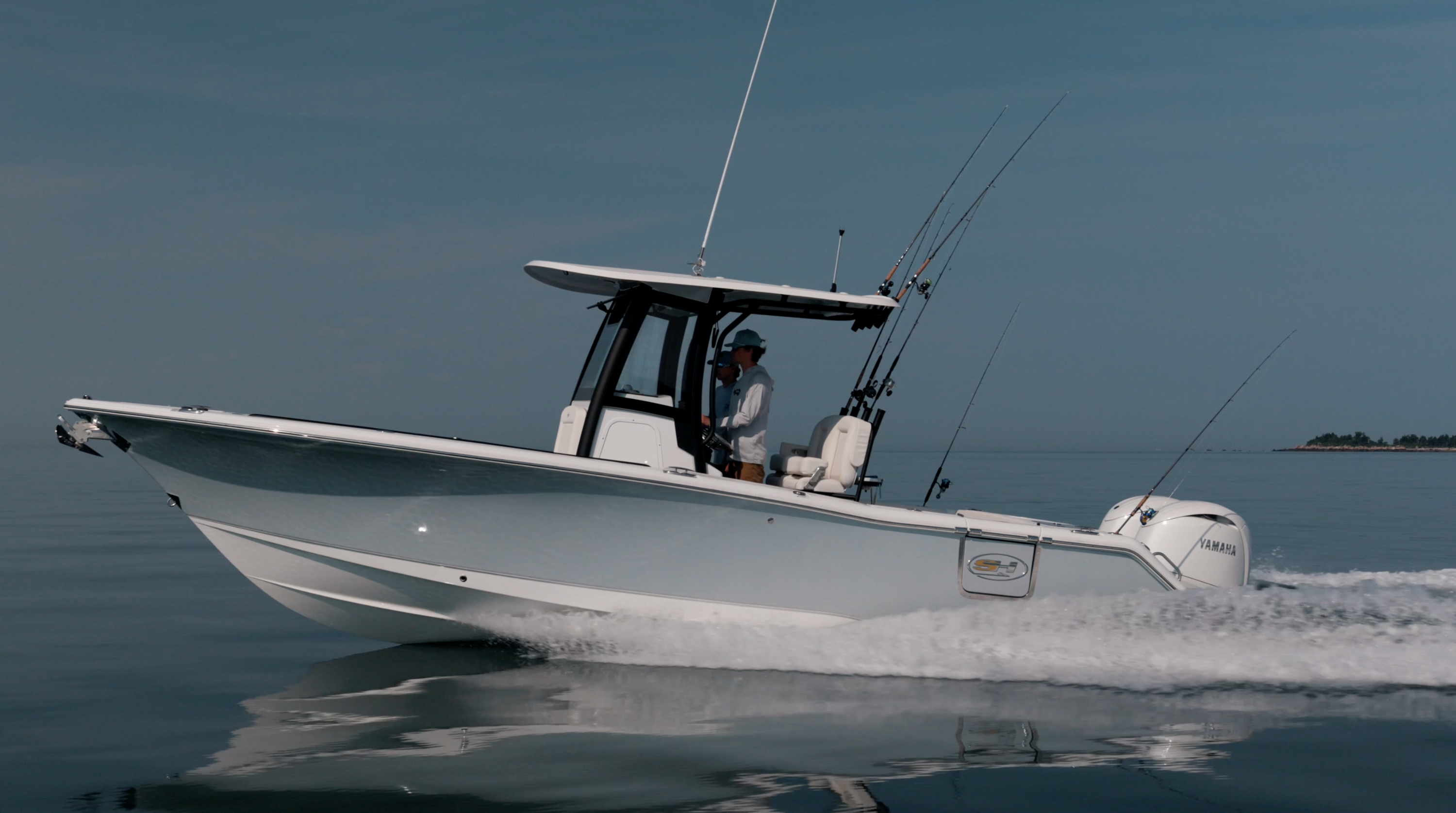 A man driving a Sea Hunt® boat speeding across the water.